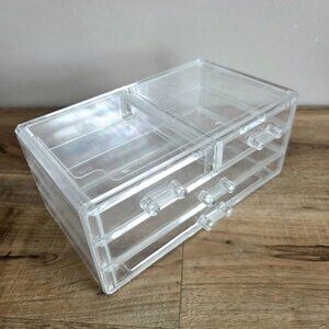 Clear plastic Lucite jewelry organizer with drawers.